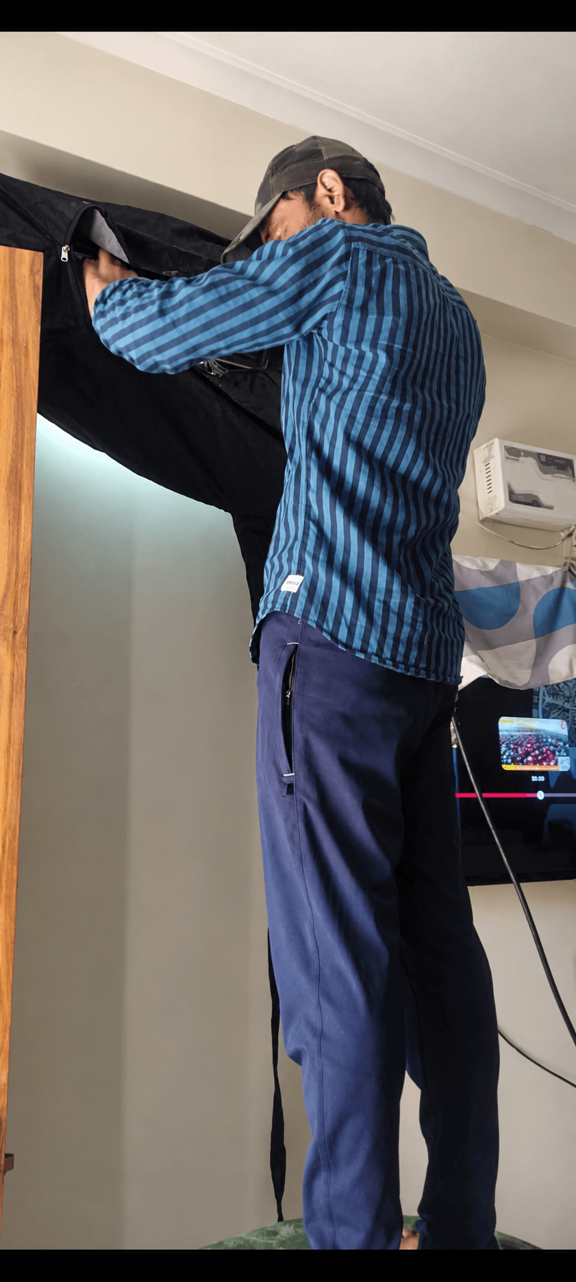 Our technician servicing a wall-mounted air conditioner inside a home